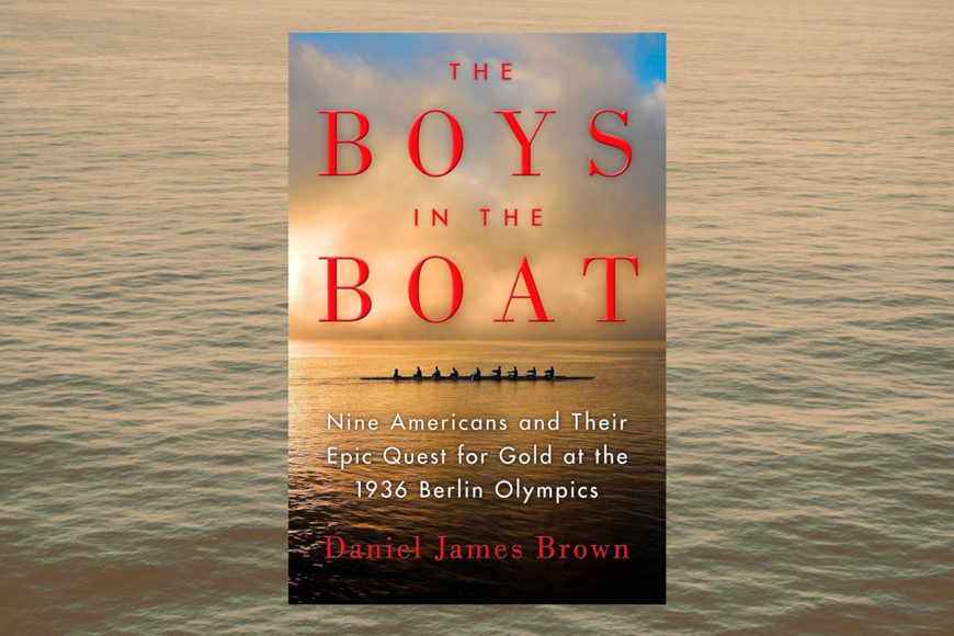Book cover shows the author's name and title against a background of 9 people sitting in profile on a rowing shell, alone on the water against a partly cloudy sky. The book cover is on a background of open water.